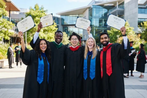 AIBM graduates celebrating with their certificates